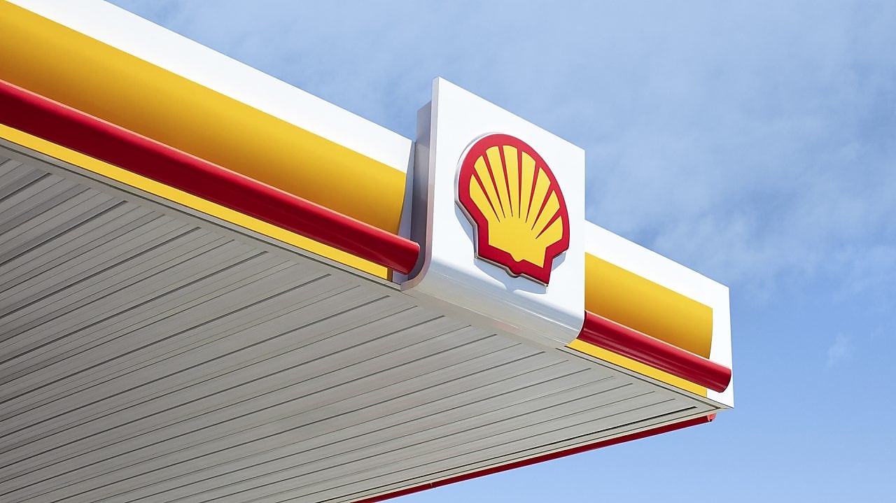 Shell station canopy set against a clear blue sky, showcasing the iconic branding.