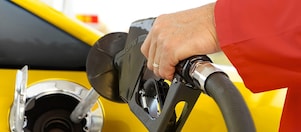 A person refueling their vehicle at a Shell fuel station, emphasizing efficient fueling practices.