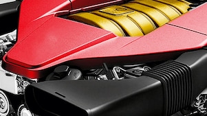 The engine of a car, with red trim and gold middle