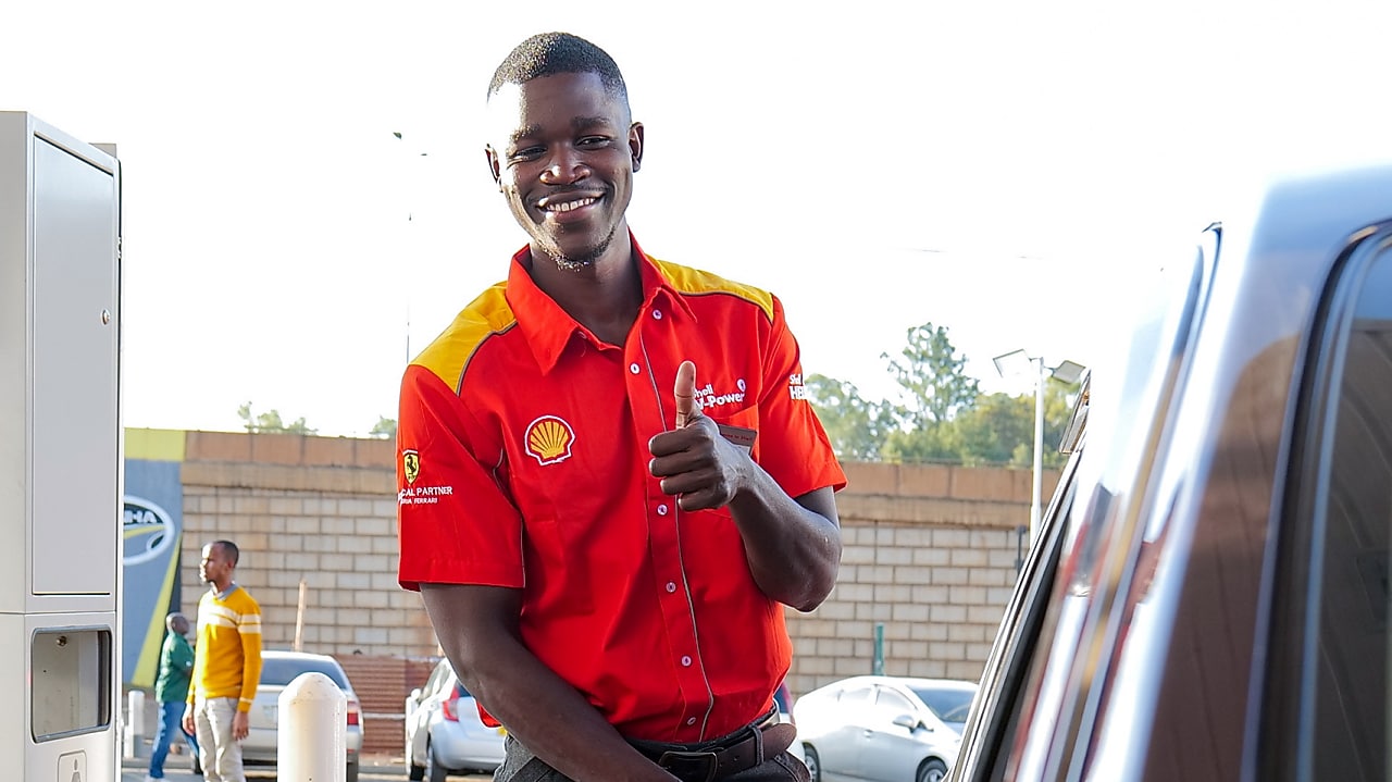 Man in shell red shirt at fuel station
