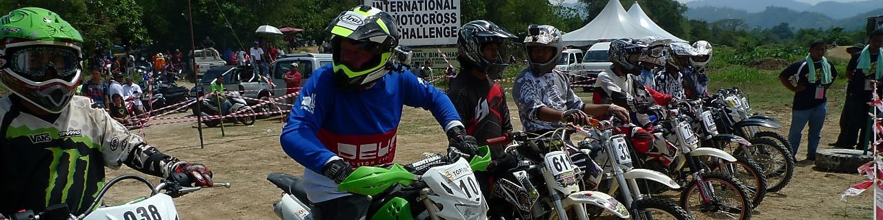 Motorcross motorcycles lining up at the start of a race