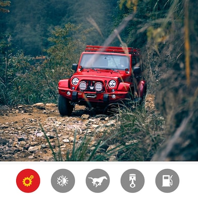 A red Jeep navigating a rough, off-road landscape, showcasing Shell Helix performance.