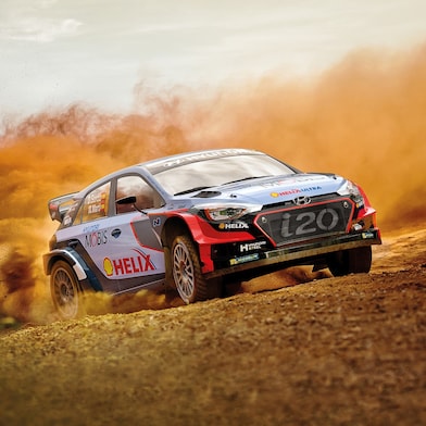 A Hyundai rally car racing on a dirt track, powered by Shell Helix lubricants.