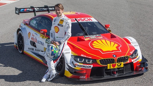 BMW motorsport driver leaning on a car which uses a bespoke Shell Helix oil formulation