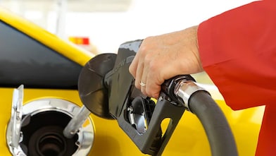 A driver refueling their vehicle at a Shell station, ensuring quality fuel for optimal performance